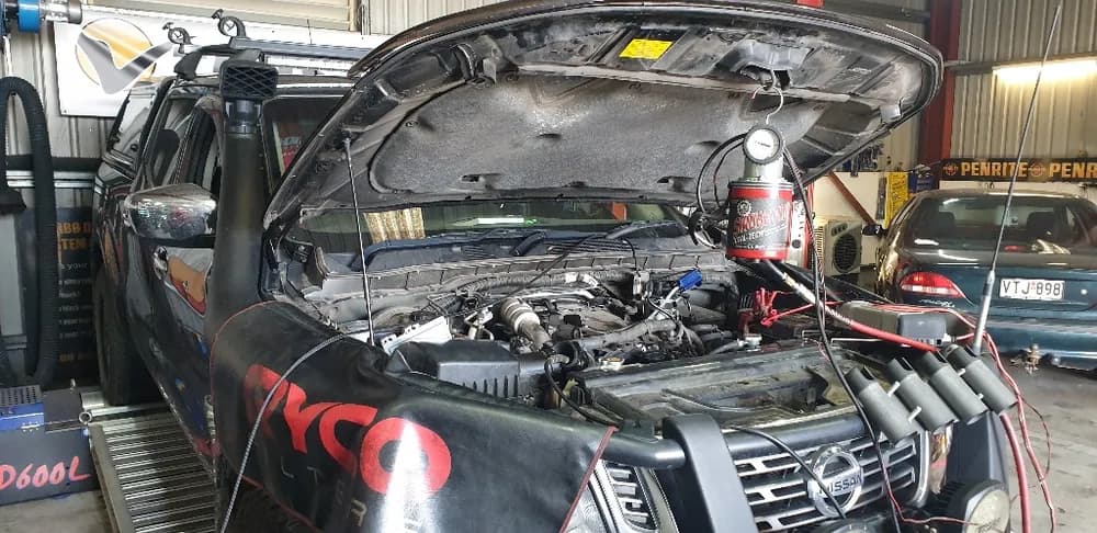 Workshop diagnostics and boost gauge on a diesel ute during a dyno tune at Trusted Mechanical, Adelaide